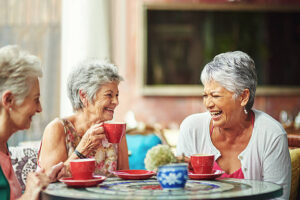A group of active senior women having their afternoon tea and talks