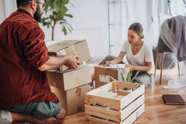 A couple categorizes stuff in their house as they make a checklist.