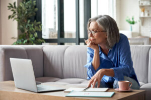 An active senior woman working on a computer.