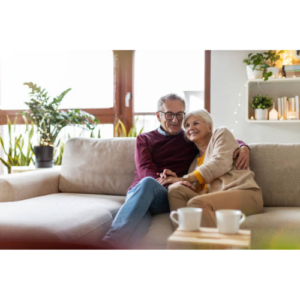 A senior couple enjoying their time together while relaxing in the sofa