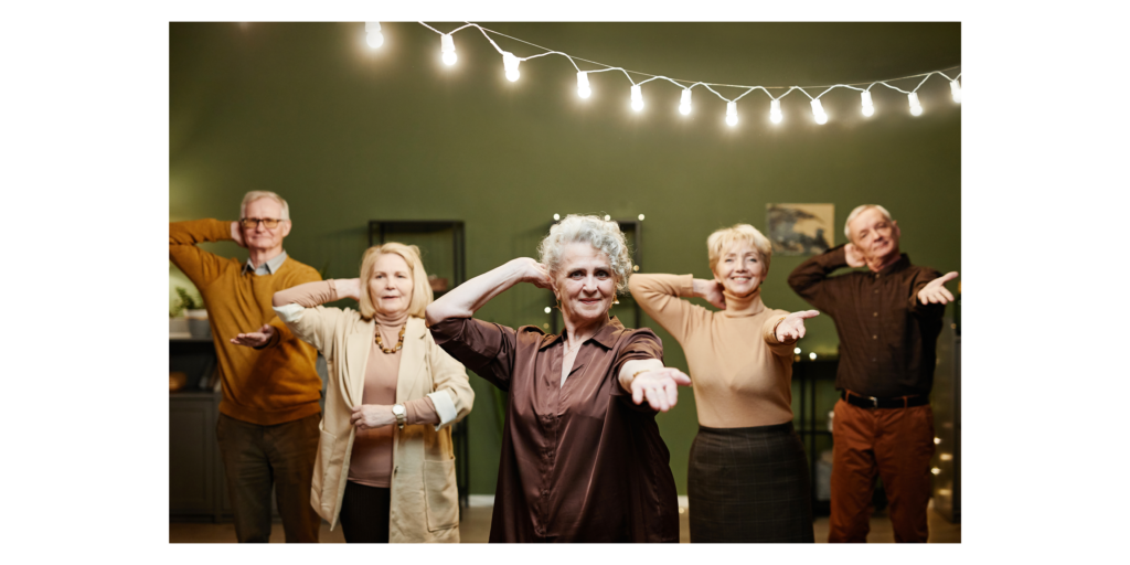 A group of fashionable active seniors posing for a dance in their senior community.