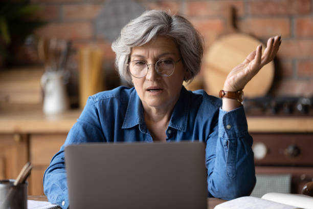 Confused elder woman on her computer